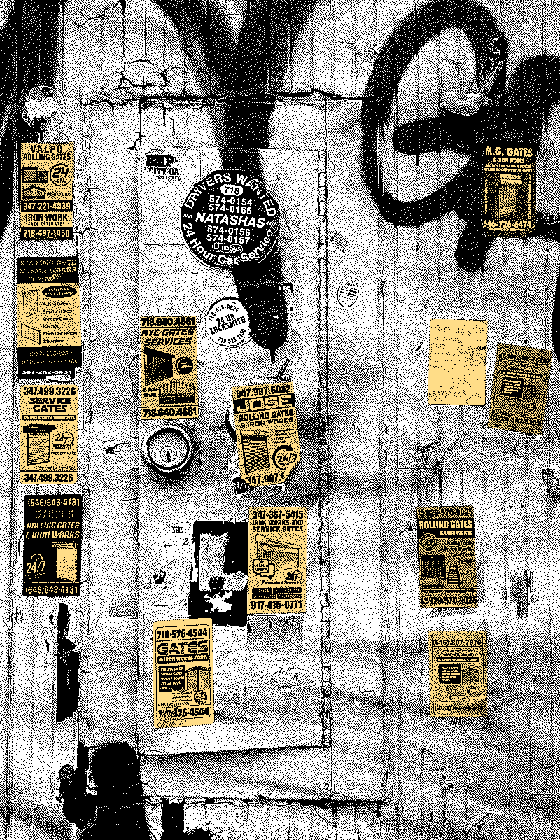 24 Hour Emergency contextual image: Photograph of rolling gate repair advertisement stickers, seen on exterior wall of business storefront.